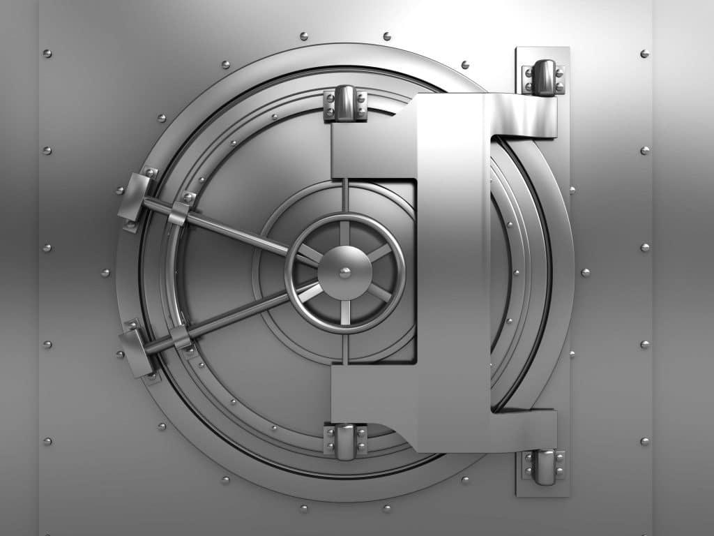 Silver vault door with a circular design, featuring a large handle and locking mechanism.